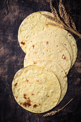Lavash flat bread on green background