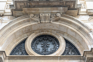 Decorative stone and metal structures on the facade of an old building, Seville, Spain