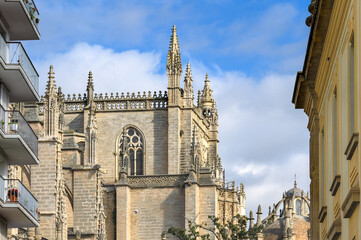 Fototapeta premium Architectural contrasts between the medieval Seville Cathedral and other buildings, Seville, Spain