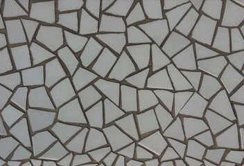 Abstract mosaic of irregular white tiles with dark grout lines