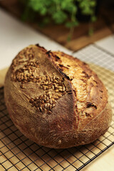 Homemade Bread Cooling on Rack with Linen Cover