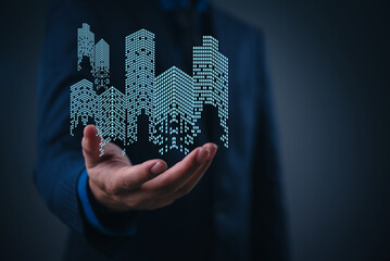 Futuristic real estate concept showing businessman with holographic skyscrapers and virtual...