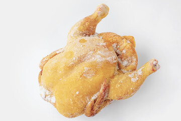 Frozen raw farm chickens, lying on a clean surface, ready to cook or process in the kitchen.