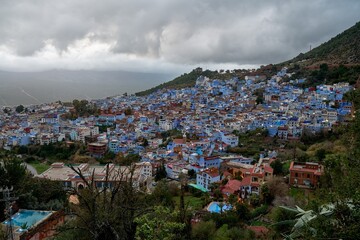 High angle sunset twilight view of the blue walled old town from Spanish Mosque hill viewpoint, Chefchaouen, Morocco