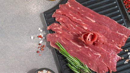 Cooking thinly sliced beef accompanied by colorful spices and herbs. Preparing carpaccio
