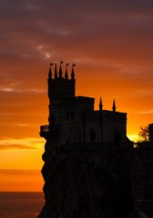 Obraz premium Sunset Silhouette of Majestic Clifftop Castle. AI Generated