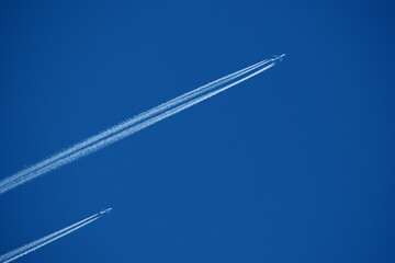 Two contrails. Airplane trail in the clear blue sky