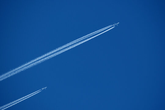 Two contrails. Airplane trail in the clear blue sky