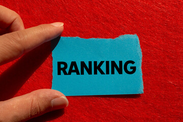 Ranking message written on ripped torn blue paper on red background. Conceptual ranking symbol....