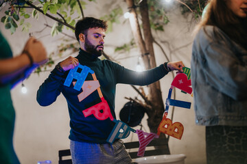 A man prepares for a birthday celebration by arranging vibrant decorations in an outdoor setting,...