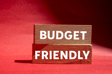 Budget friendly message written on wooden blocks on red background. Conceptual budget friendly symbol. Copy space.