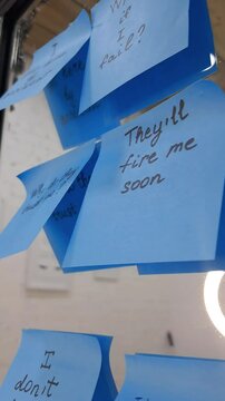 Sticky notes represent self-doubt and the emotional struggle of imposter syndrome.