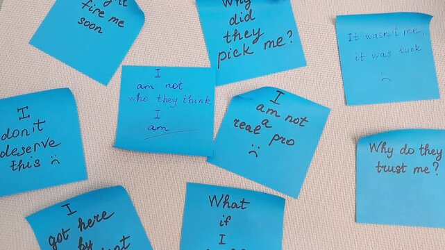 Sticky notes represent self-doubt and the emotional struggle of imposter syndrome.