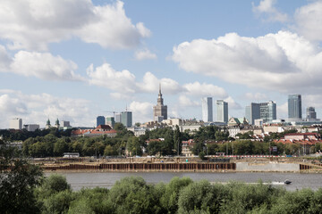 Fototapeta premium Distant view of Warsaw from across the Vistula River, blending history with skyline reflections.
