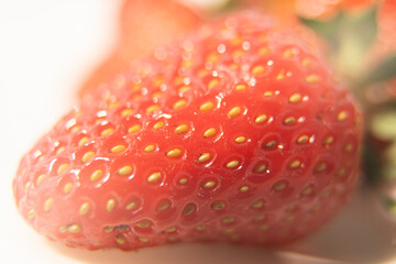 Close-up texture detail of a strawberry, See the seeds attached to the outer surface, red, beautiful.