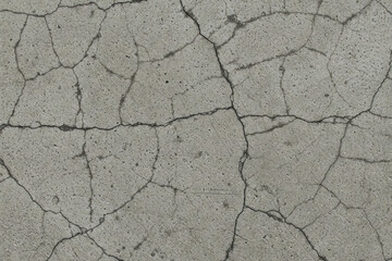 Obraz premium Cracked concrete surface texture with intricate lines and patterns. Ideal for grunge backgrounds, urban design, or industrial themes.