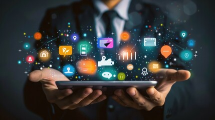 A businessman is holding a tablet with a colorful screen displaying various icons