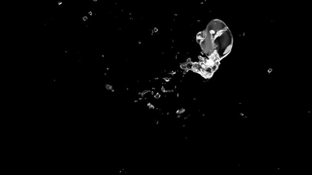 Splash of a drop in zero gravity on a black background.