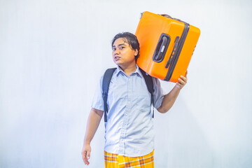 Portrait Asian muslim man carrying suitcase . Concept Going home for Eid Mubarak. Isolated image on white background