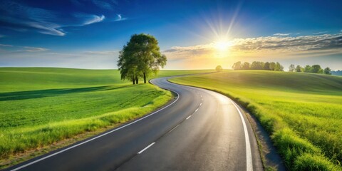 Fototapeta premium Asphalt road curving through vibrant green fields under a bright sunlit sky, a picturesque journey ahead
