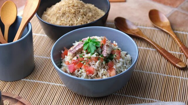 rice with mackerel and tomato in the bowl - close-up