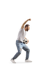 Full length profile shot of an ecstatic man cheering with a football