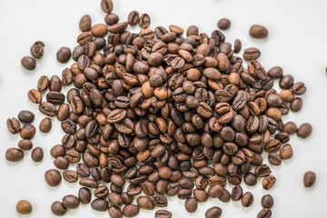 Whole coffee beans on a light background