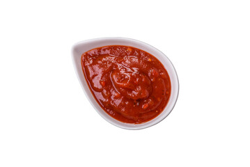 Red sauce or ketchup with salt and spices in ceramic sauce boat