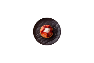 Round sweet tart with strawberry pieces and cream