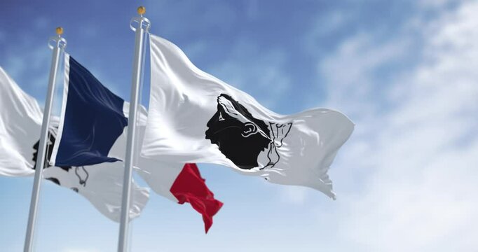 Flags of Corsica waving in the wind on a clear day
