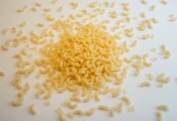 Obraz premium Curly pasta scattered on white background 