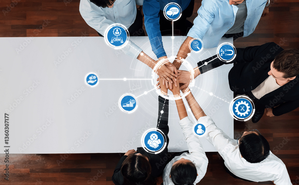 Poster A top view of a diverse team collaborating around a table, showcasing hands interlinked with digital icons, representing innovation, technology, and business productivity. Amity