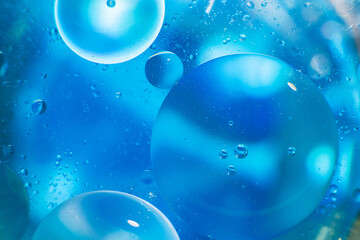 Oil bubbles close up. circles of water macro. abstract light blue background