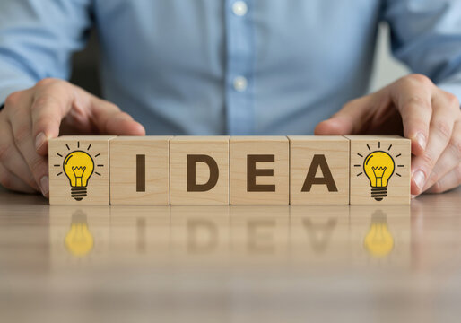 Wooden Blocks Spelling IDEA with Lightbulb Icons Representing Creative Thinking