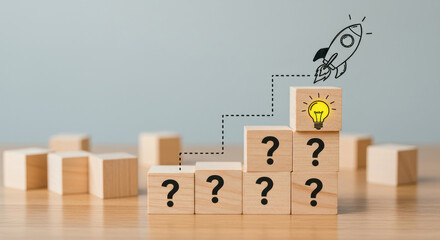 Wooden Blocks Stacked with Question Marks and Rocket Icon Representing Progression of Ideas