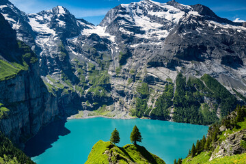 Switzerland travel - Scenic view high above the Oeschinen lake in the Swiss Alps near Kandersteg.  Popular hiking around the turquoise-colored lake with majestic views of waterfalls and the Doldenhorn © Kathy images