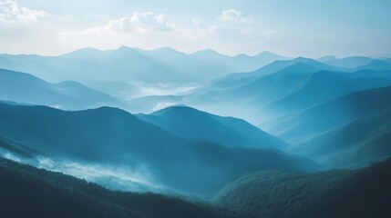 Fototapeta premium Aerial view of a vast mountain range with mist covering the peaks. 