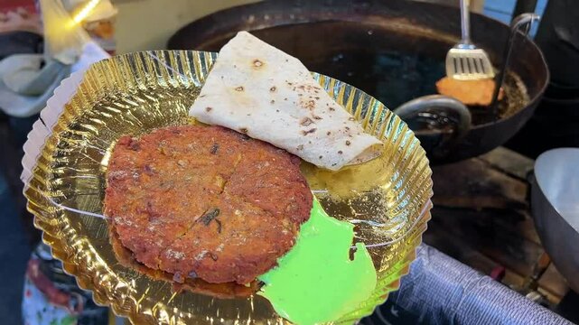 Close up shot of Mutton chapli kabab with Rumali roti and green dhaniya chutney