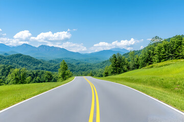 Fototapeta premium Scenic mountain road journey, winding asphalt path through lush green hills under a vibrant blue sky