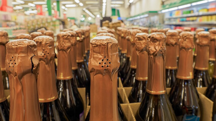 Champagne. A showcase of alcoholic beverages in a supermarket. Consumerism.