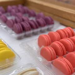 Traditional delicious French multicolored pasta on the shelf for sale in the supermarket. Delicious sweets. Close-up