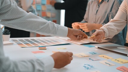 Collaborative brainstorming session with sticky notes and color palettes showcasing team...