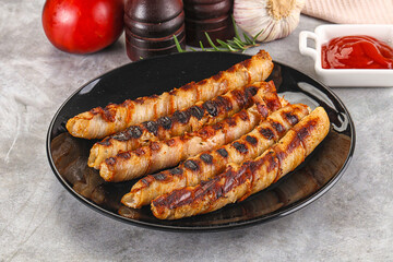 Grilled meat sausages wrapped bacon