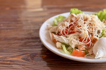 A Freshly Rendered Salad made with Crisp Lettuce and a Deliciously Creamy Dressing. A vibrant and colorful plate of fresh salad featuring tender shredded chicken, crisp lettuce, and a creamy side