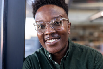 In office, professional wearing glasses working confidently with positive attitude