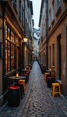 Fototapeta premium Cozy cobblestone alley with outdoor seating and warm lights at dusk