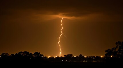 Nighttime lightning strike illuminating dark landscape
