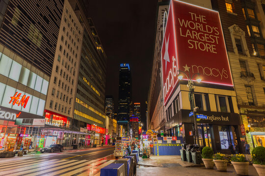 Night view of Macy's store at intersection of 34th Street and Broadway with glowing lights and illuminated signs. New York. USA.