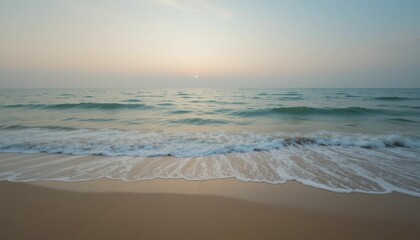 Obraz premium Tranquil Sunrise Over Calm Ocean Waves at Serene Sandy Beach