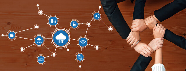 Explore a visual representation of teamwork in computing, showcasing collaborative efforts and cloud technology icons over a wooden table background. Amity